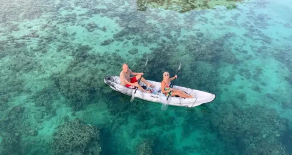 Kayaking over clear water on the Khasab dhow cruise