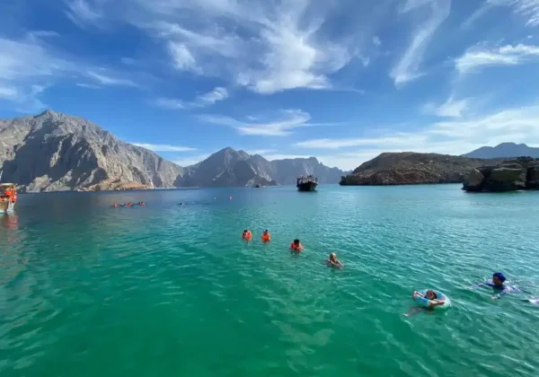 Guests swimming in a fjord bay on the Khasab dhow cruise