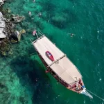 Private dhow at anchor in clear water on the Musandam overnight dhow cruise