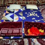 Mattresses and pillows laid out on deck for the night on the overnight dhow