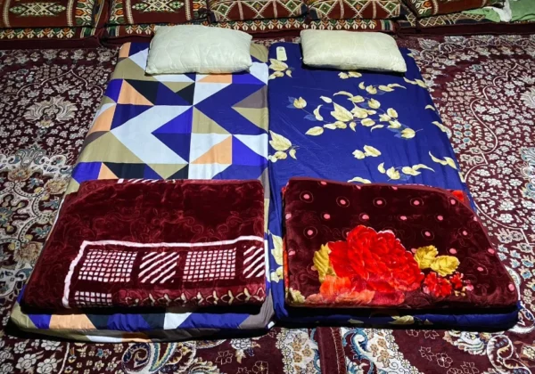 Mattresses and pillows laid out on deck for the night on the overnight dhow